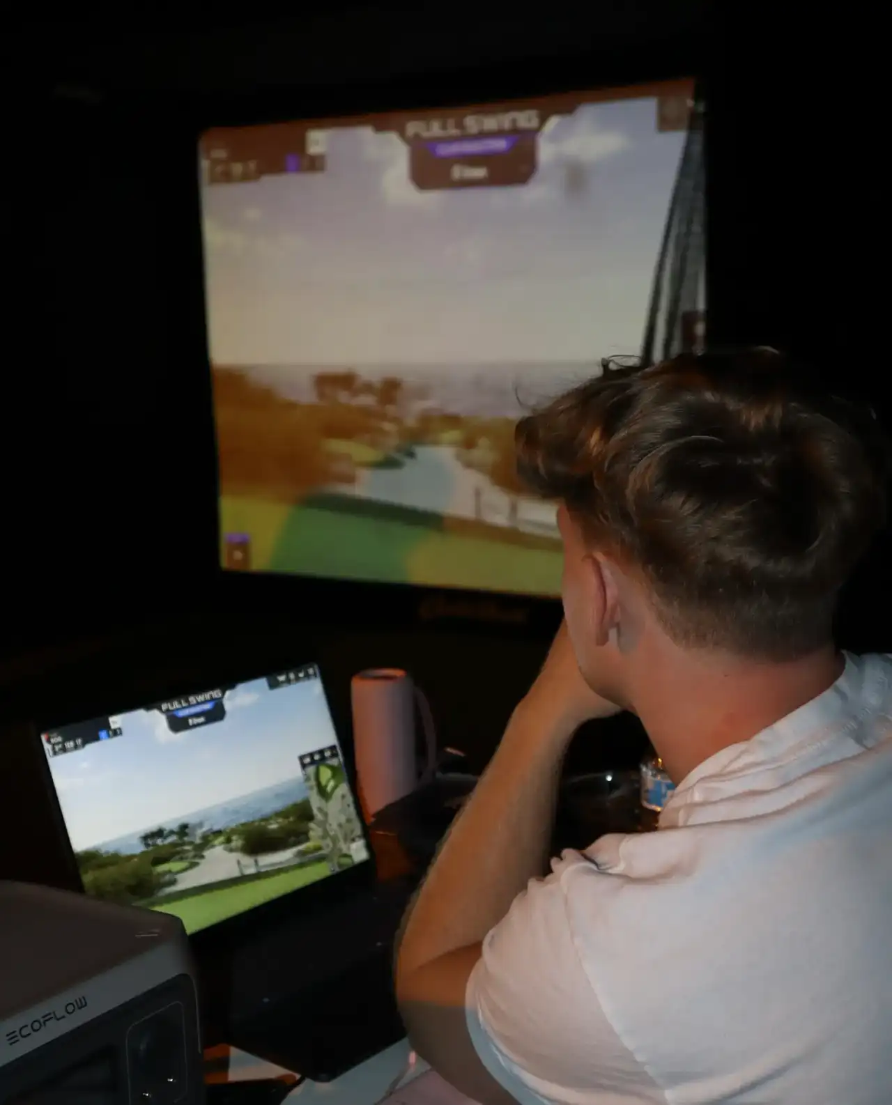 Player watching Full Swing portable golf simulator screen at an Ohio event