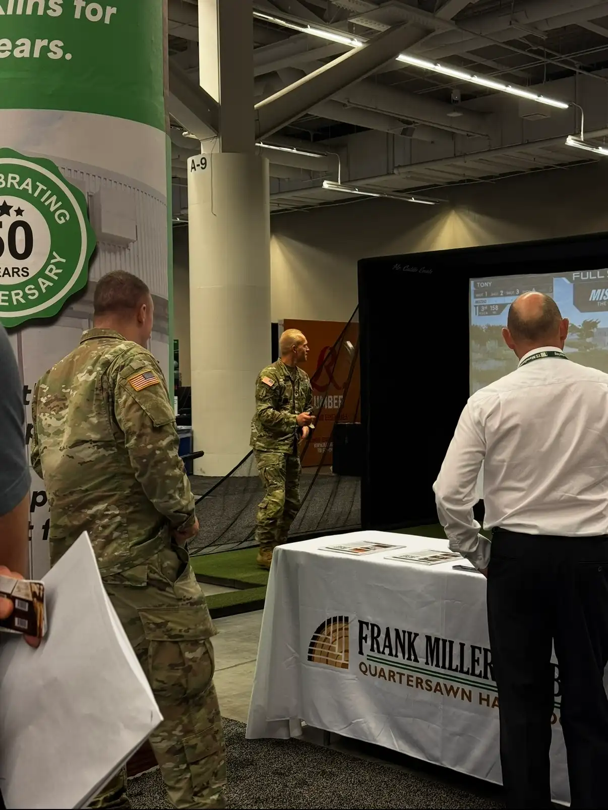 Guest swinging on the Mr. Caddie Events portable golf simulator at a conference